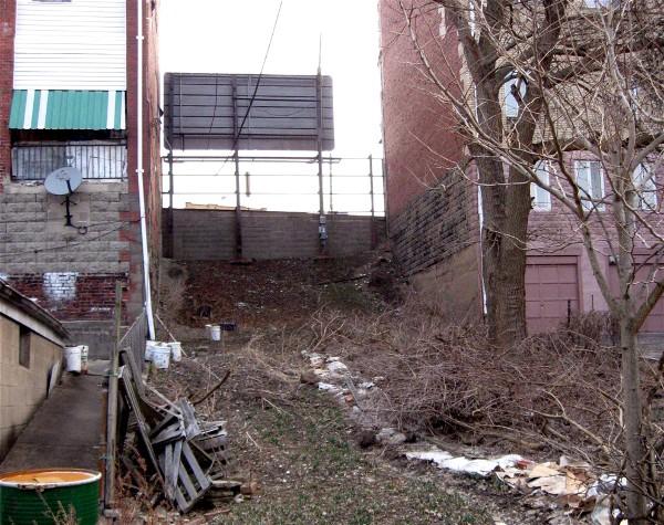 The open lot between 956 and 962 Brookline Boulevard,
showing the billboard and the drainage pipe.