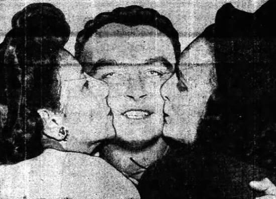 Lt. Richard A Bauer, center, gets a
welcome home kiss from his mother and wife.