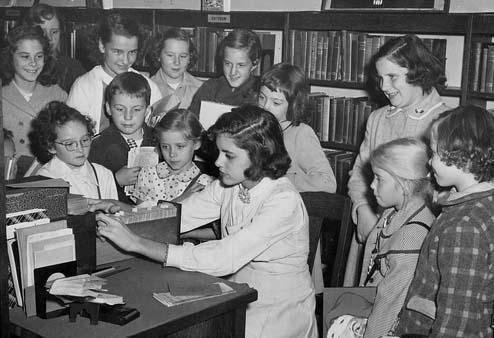Picture of kids using the card catalog
 at the old Brookline library. - 1960s