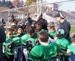 Coaches and players gather
around the 2006 SSYFL championship
trophy. It was a heartwarming moment
on an otherwise bonechilling day!