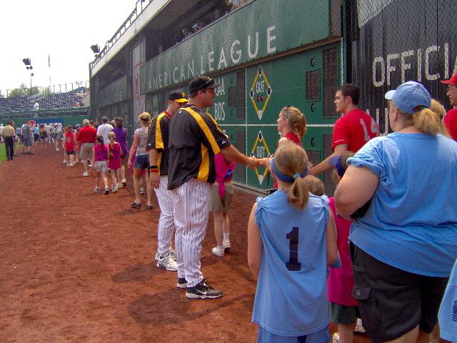 Morgan Burton is greeted by a member of
 the Pirate team as she enters the field area.