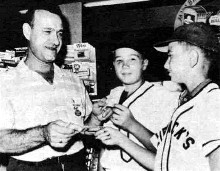 Brookline Little Leaguers Joe and
Jackie Klingensmith go door-to-door
on collection day. Here, merchant
Morris Grummet gives a contribution