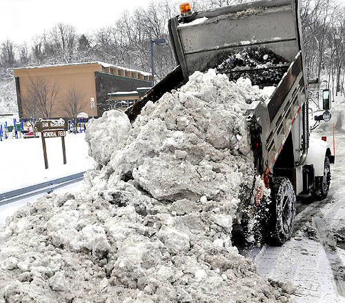 Feb 12 - The city trucks began dumping snow in the
lower parking lot during the neighborhood Snow Blitz.
(Post-Gazette Photo - Click on photo for P-G article)