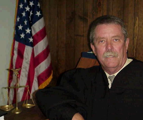 District
 Justice Charlie McLaughlin.
