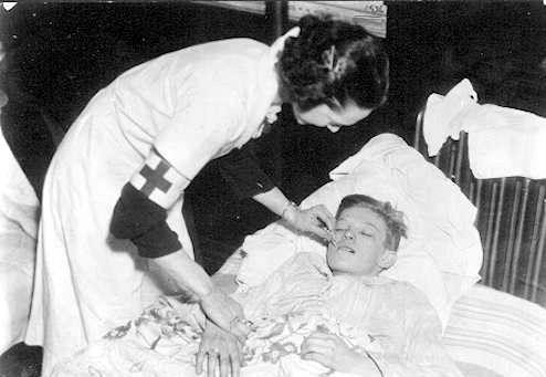 A Red Cross nurse tends
 to one of the stranded children during the Great St. Patrick's Day Flood
