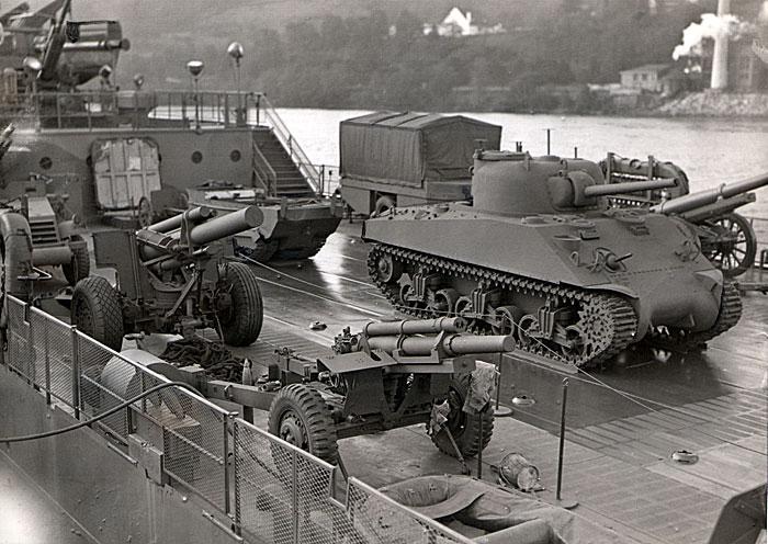 The deck of the LST is loaded
with an impressive display of armaments.